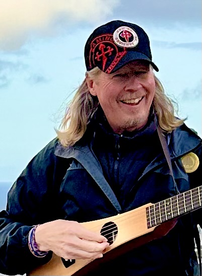 Dave Hall smiling while playing a stringed instrument