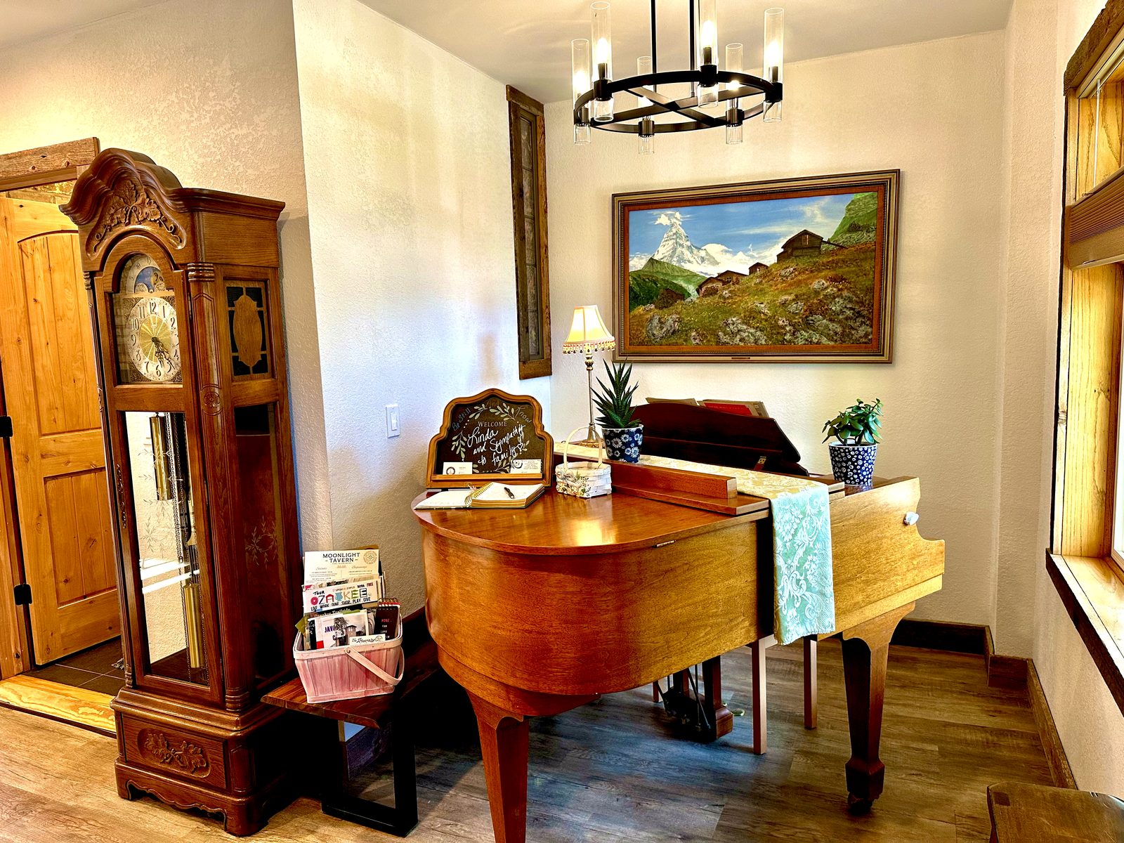 Baby grand piano beside an antique grandfather clock