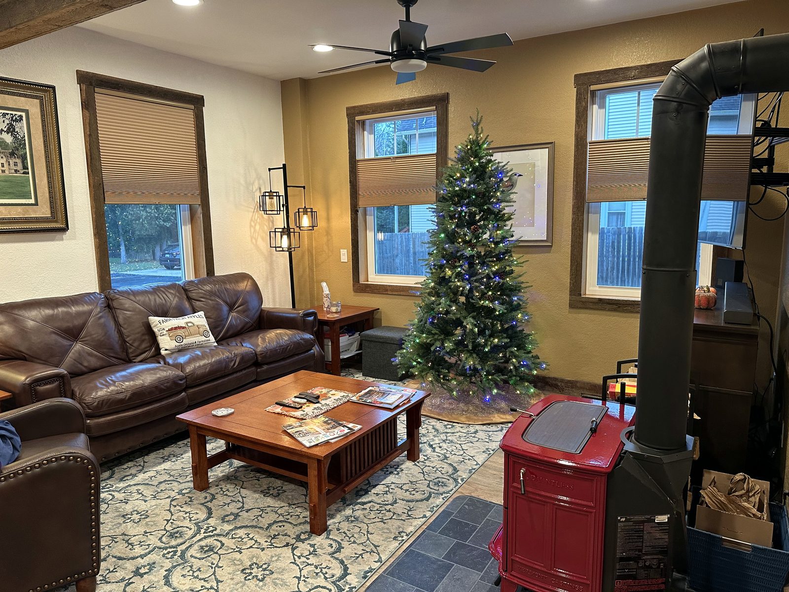 Living room sectional beside the red wood stove