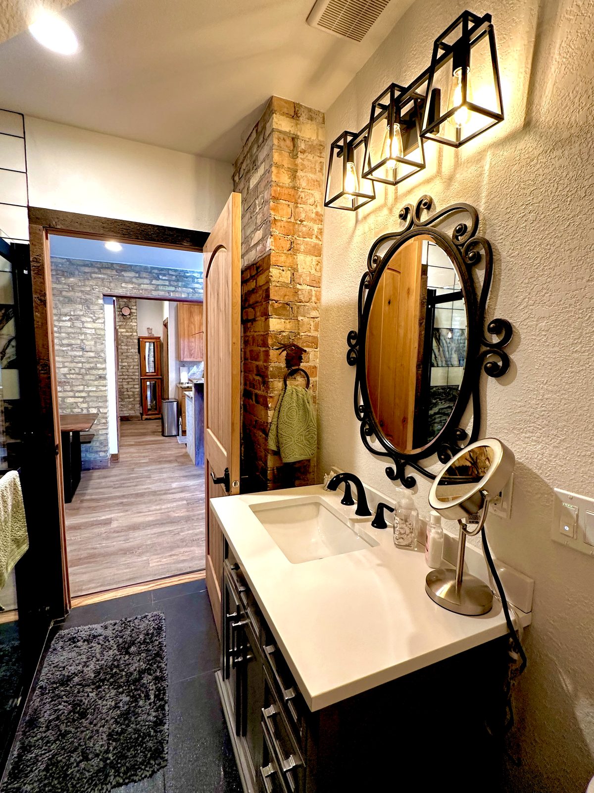 Second bathroom vanity and exposed Cream City Brick