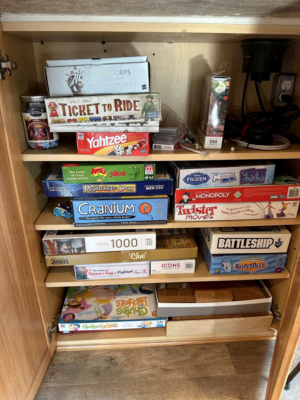 Cabinet stocked with board games and puzzles