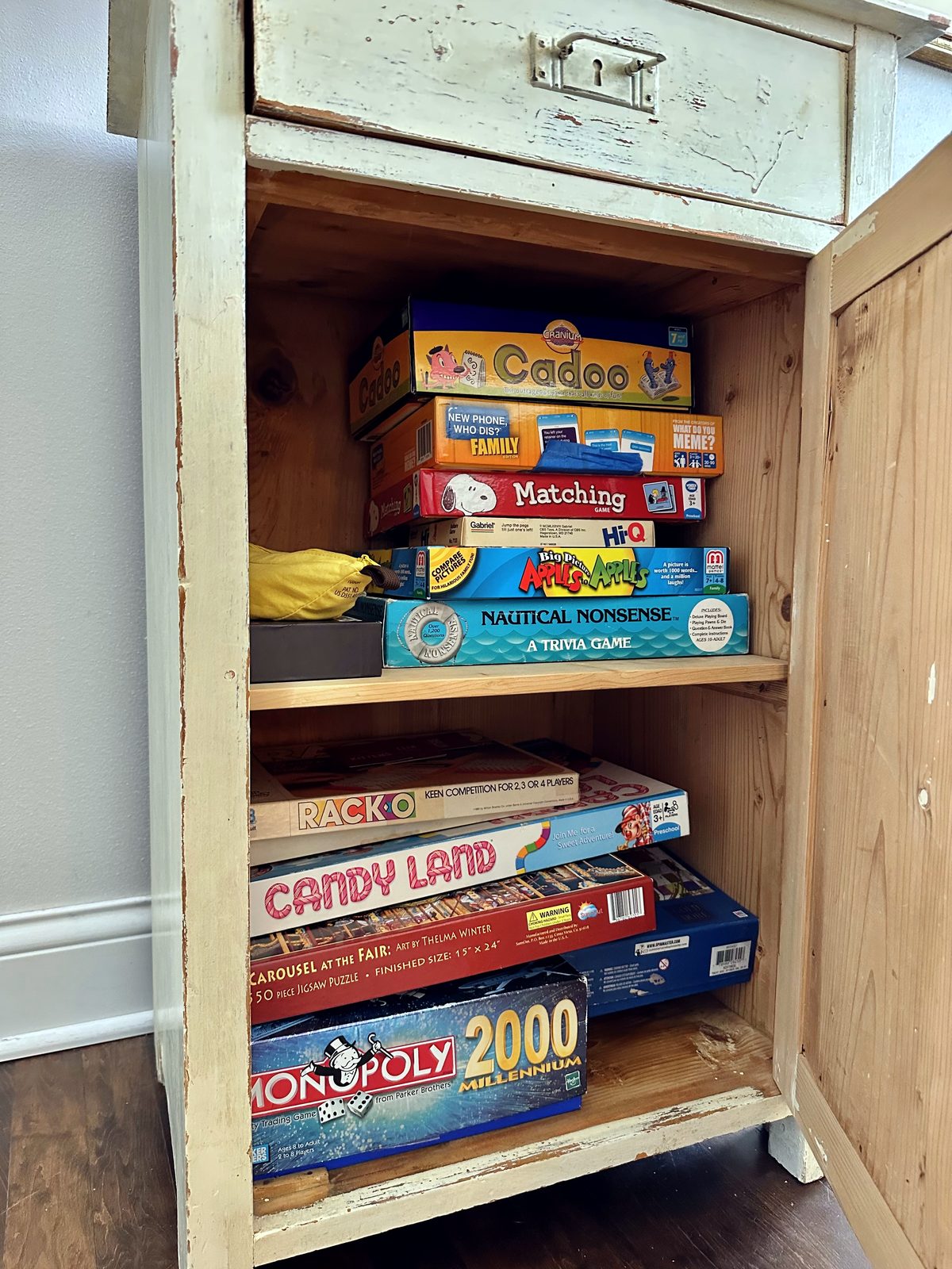 Cabinet stocked with board games for families
