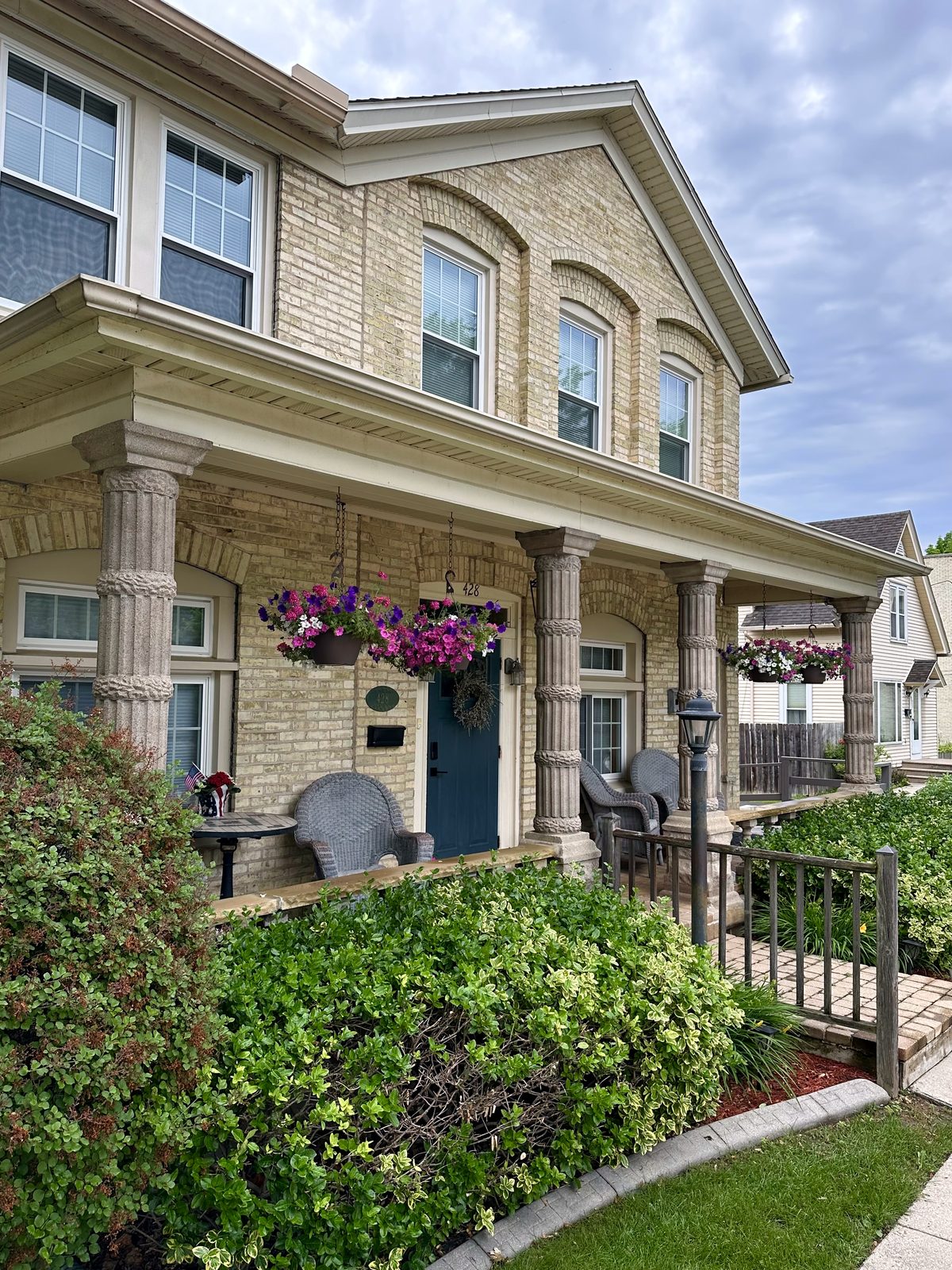 Corner view of the house with porch flowers