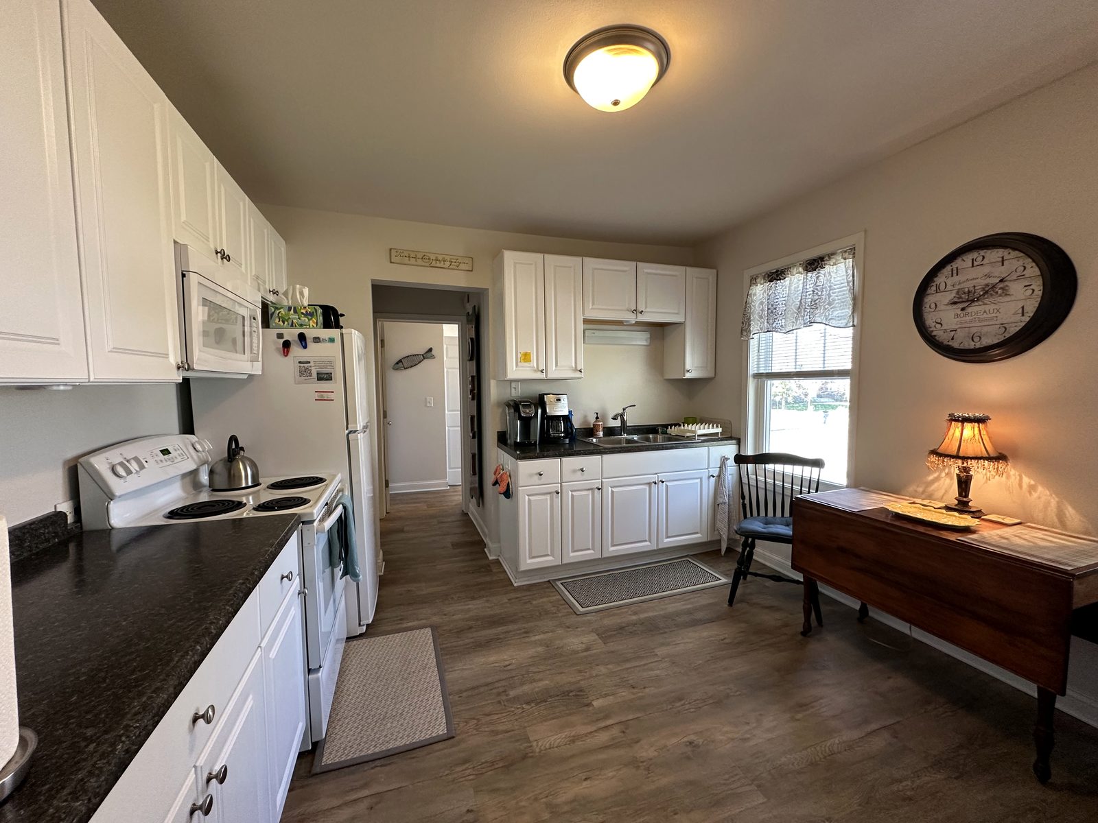 Kitchen with range, coffee makers, and dining table