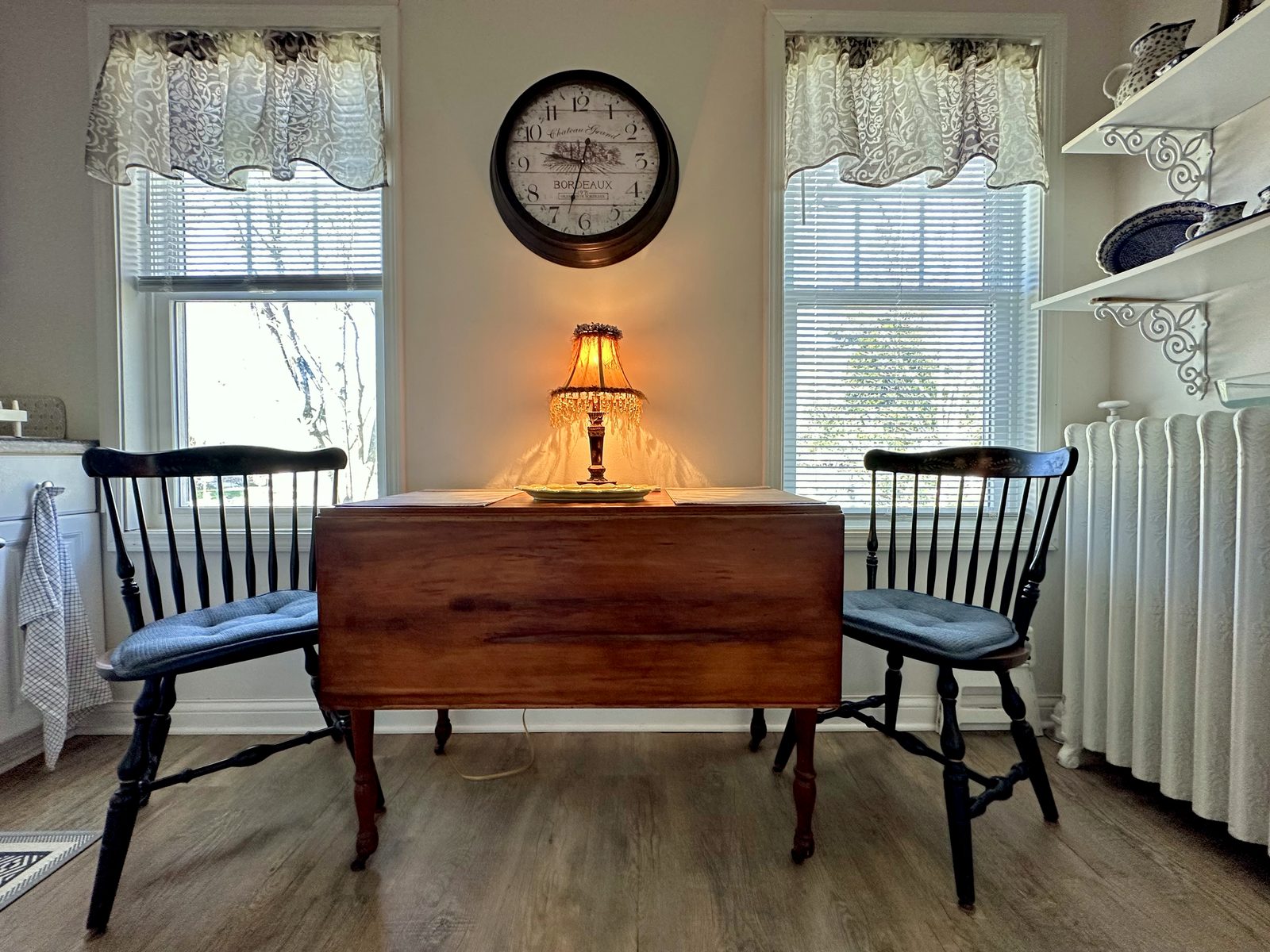 Breakfast nook with wooden drop-leaf table and two chairs