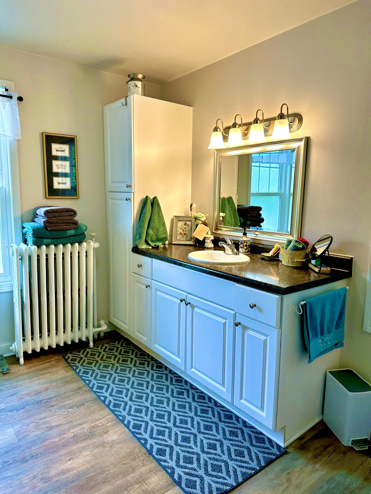 Bathroom vanity with mirror and stacked towels