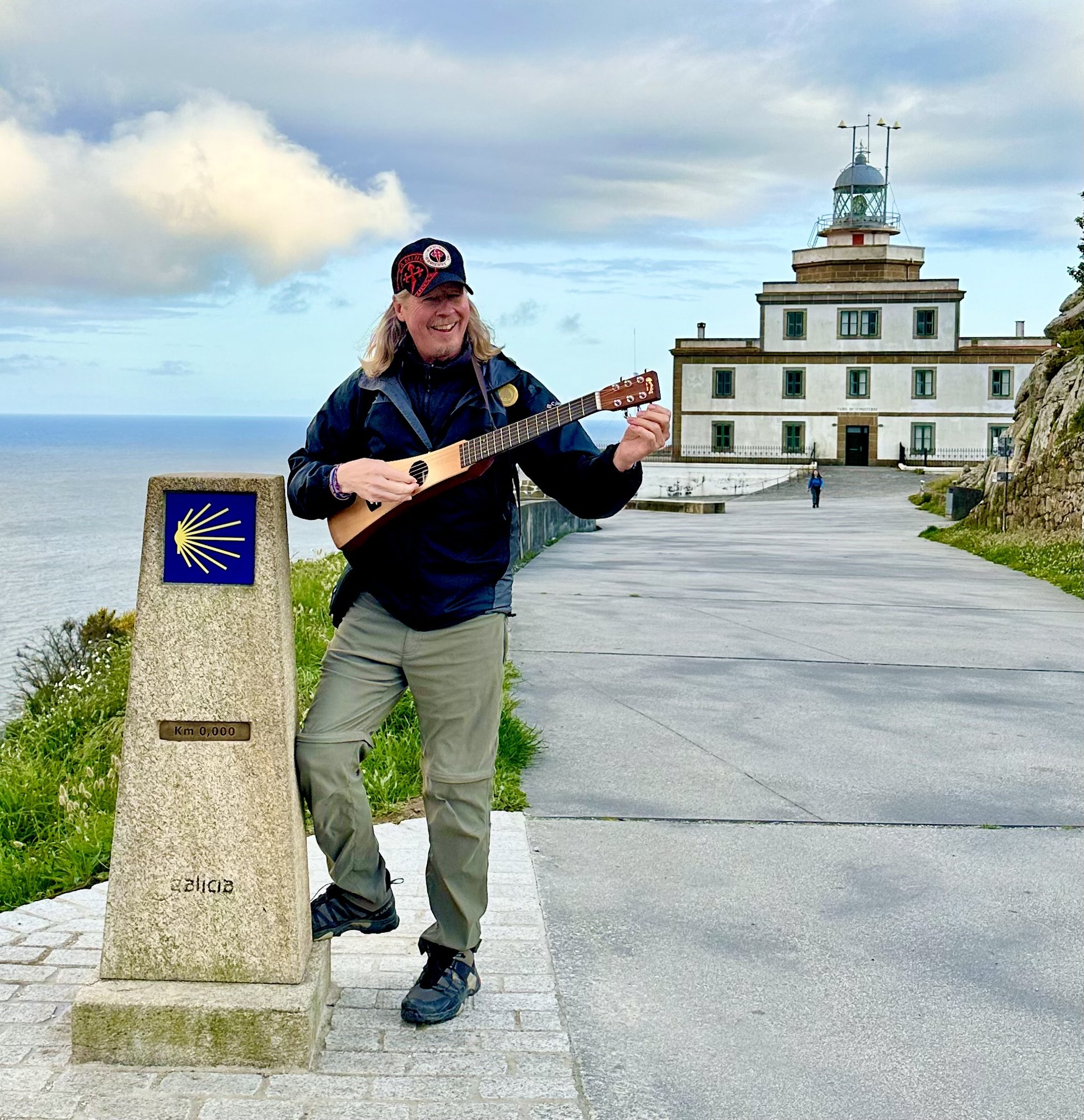 Dave playing guitar at the Finisterre lighthouse
