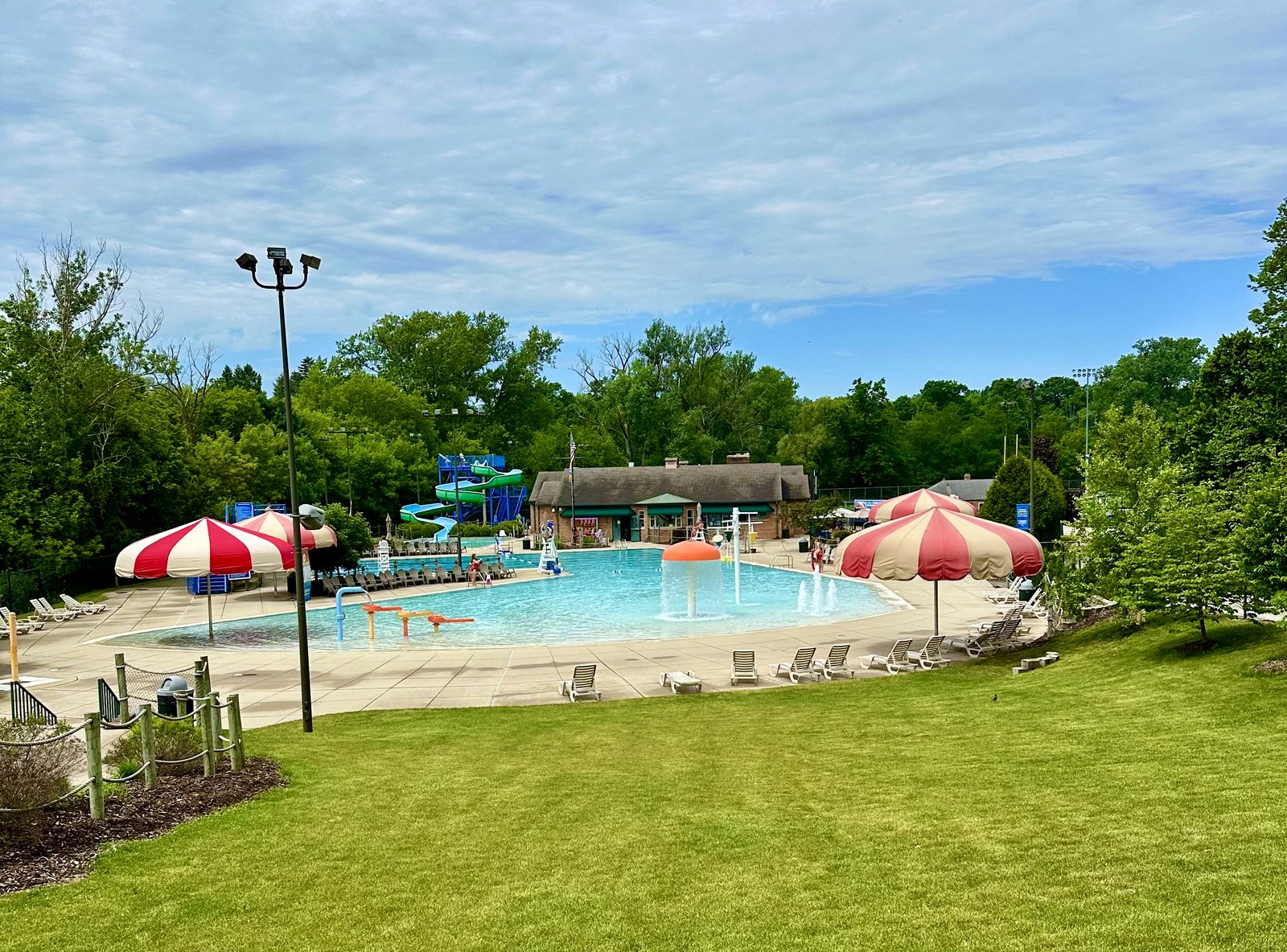 Pirates' Hollow Community Water Park pool, slides, and umbrellas